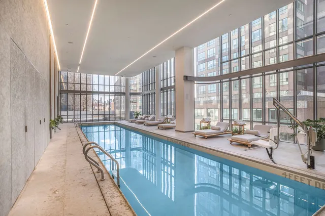 a view of a hallway with wooden floor and white walls
