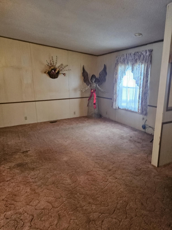504 Loop Road Savoy, MA 01256 - Photo 6 of 12 a view of a livingroom with an empty space and a window