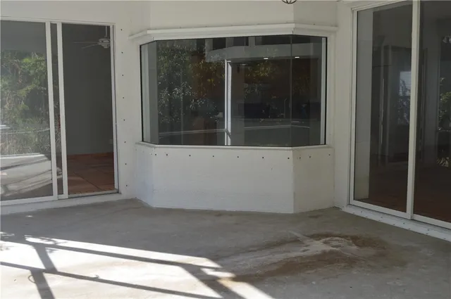 a view of a livingroom with an empty space and a window