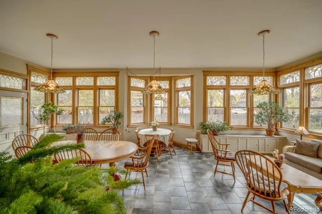 a living room with furniture and floor to ceiling windows