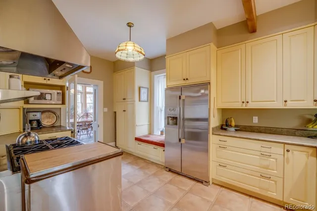 a kitchen with kitchen island granite countertop a stove and a refrigerator