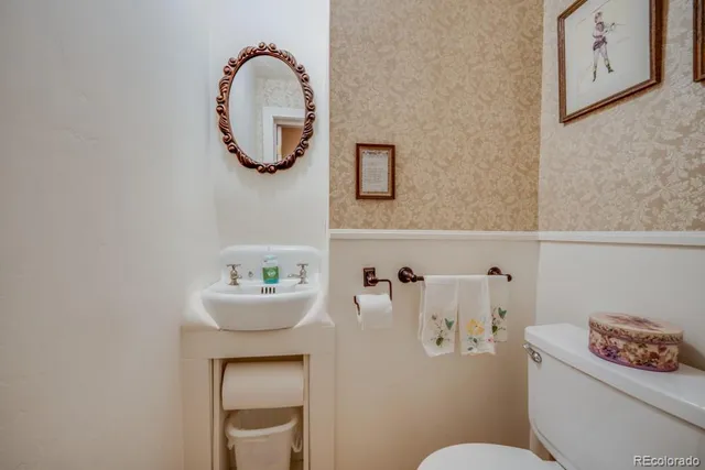a bathroom with a sink mirror and toilet