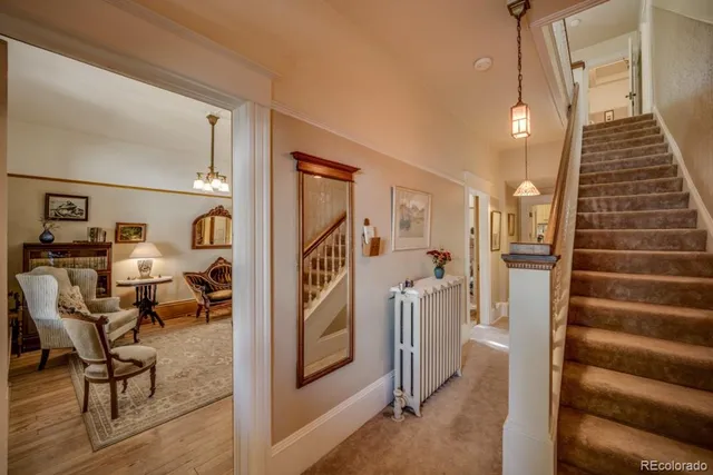 a view of a hallway with wooden floor and windows
