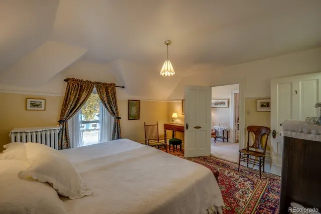 a bedroom with a bed and a dresser with mirror