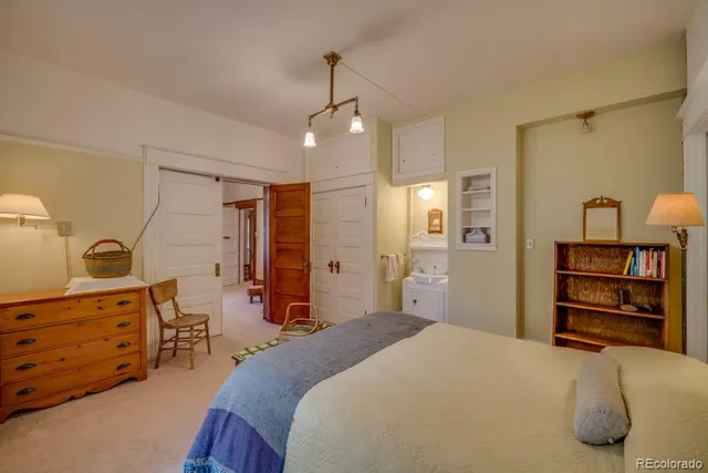 a bedroom with a bed dresser and a window