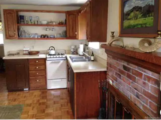 a kitchen with granite countertop a sink and a stove