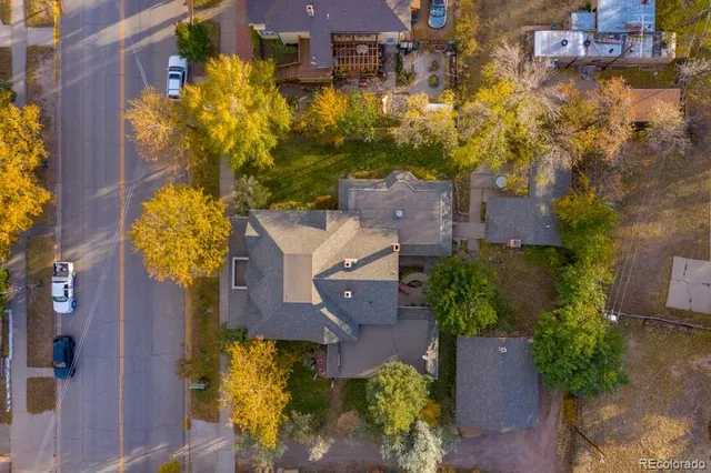 an aerial view of residential houses with yard