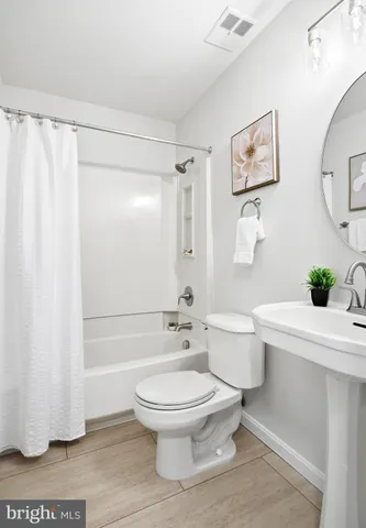 a bathroom with a toilet a sink and a shower