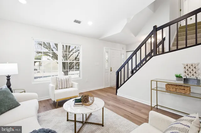 a living room with fireplace furniture and a window