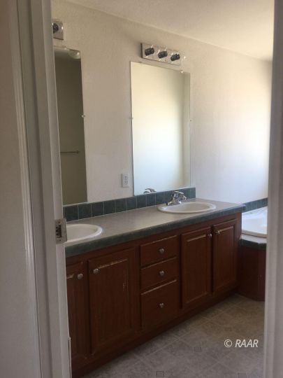1409 Pinto Street Ridgecrest, CA 93555 - Photo 9 of 12 a bathroom with a sink and a mirror