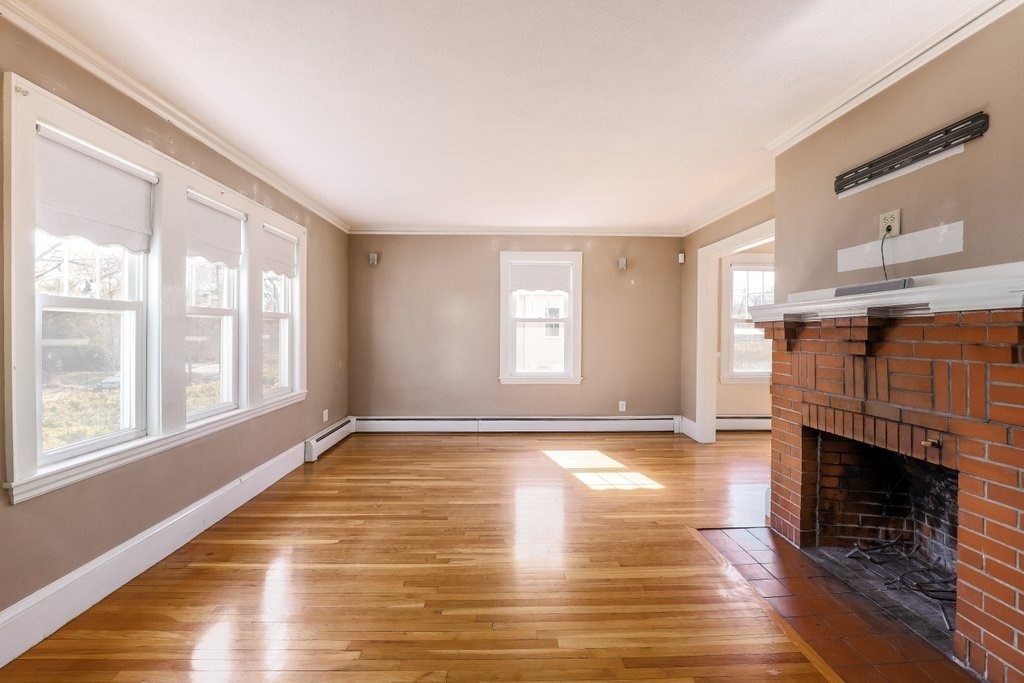 8 Smith Avenue Reading, MA 01867 - Photo 15 of 32 a view of an empty room with wooden floor and a window