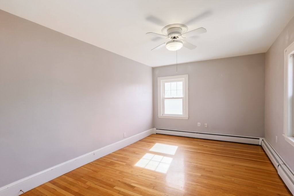8 Smith Avenue Reading, MA 01867 - Photo 18 of 32 a view of an empty room with wooden floor and a window