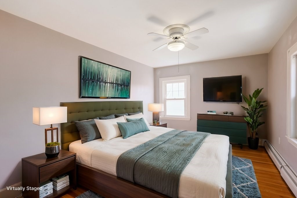 8 Smith Avenue Reading, MA 01867 - Photo 19 of 32 a bedroom with a bed and a flat screen tv