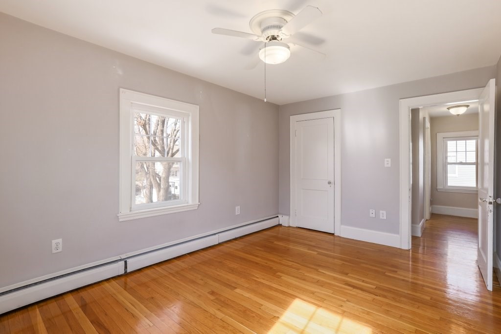 8 Smith Avenue Reading, MA 01867 - Photo 20 of 32 a view of empty room with wooden floor and fan