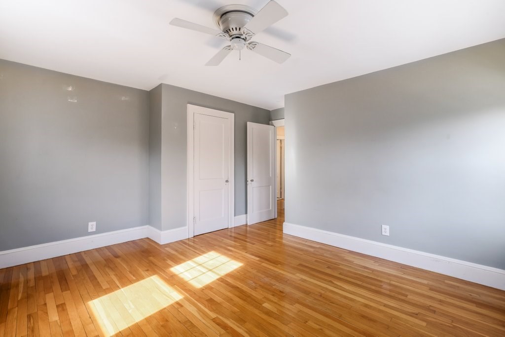 8 Smith Avenue Reading, MA 01867 - Photo 22 of 32 a view of a room with wooden floor and a ceiling fan
