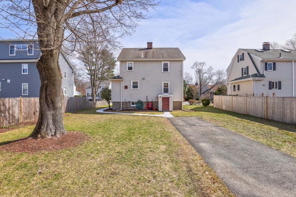 8 Smith Avenue Reading, MA 01867 - Photo 4 of 32 a front view of a house with a yard