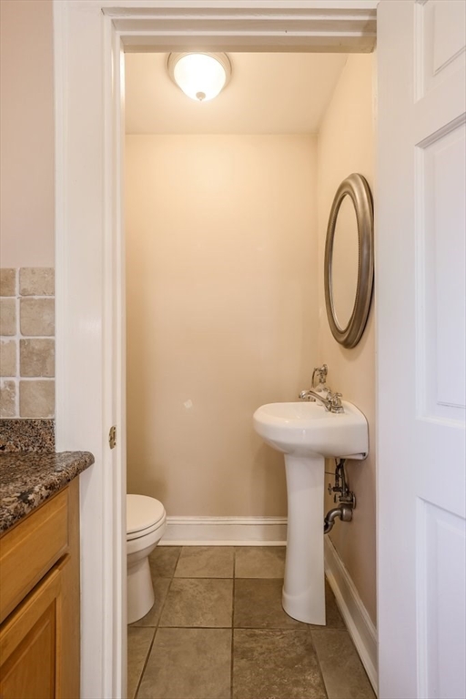 8 Smith Avenue Reading, MA 01867 - Photo 10 of 32 a bathroom with a sink toilet and a mirror