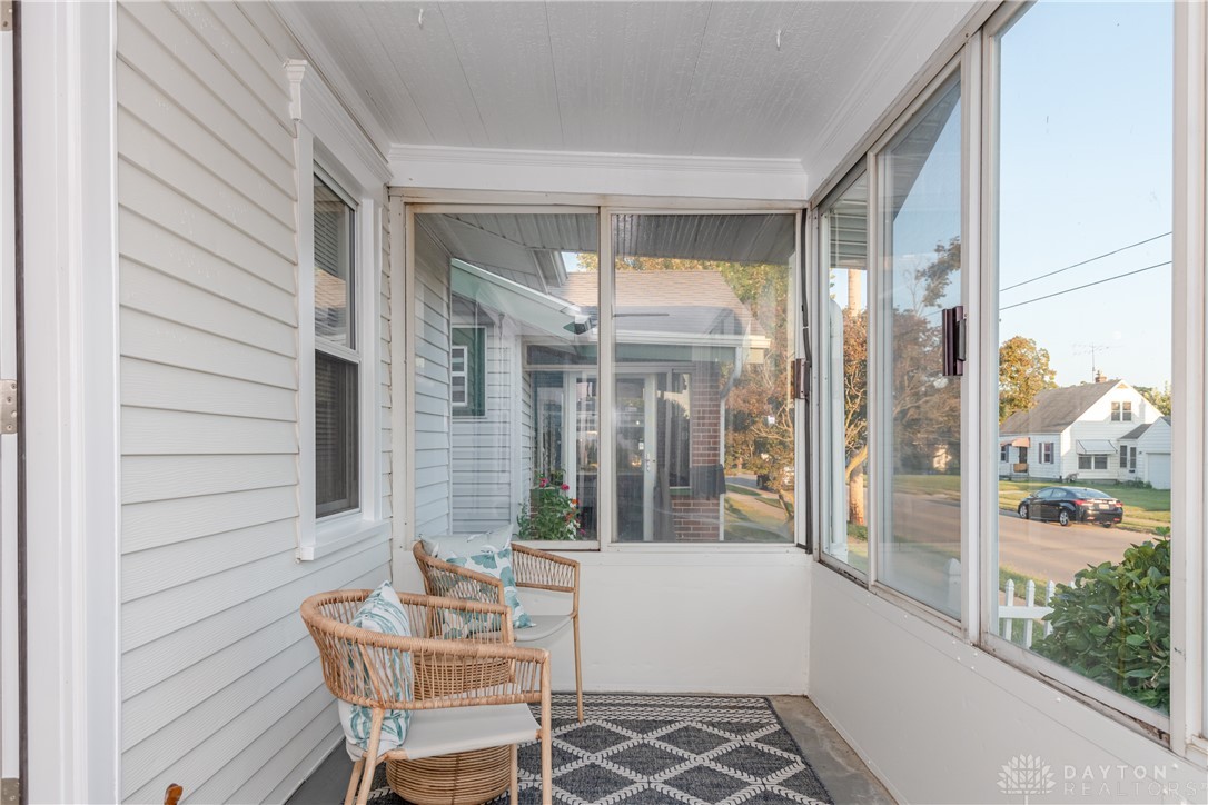 1915 Patterson Road Dayton, OH 45420 - Photo 4 of 48 This inviting enclosed porch offers a peaceful retreat with charming neighborhood views.