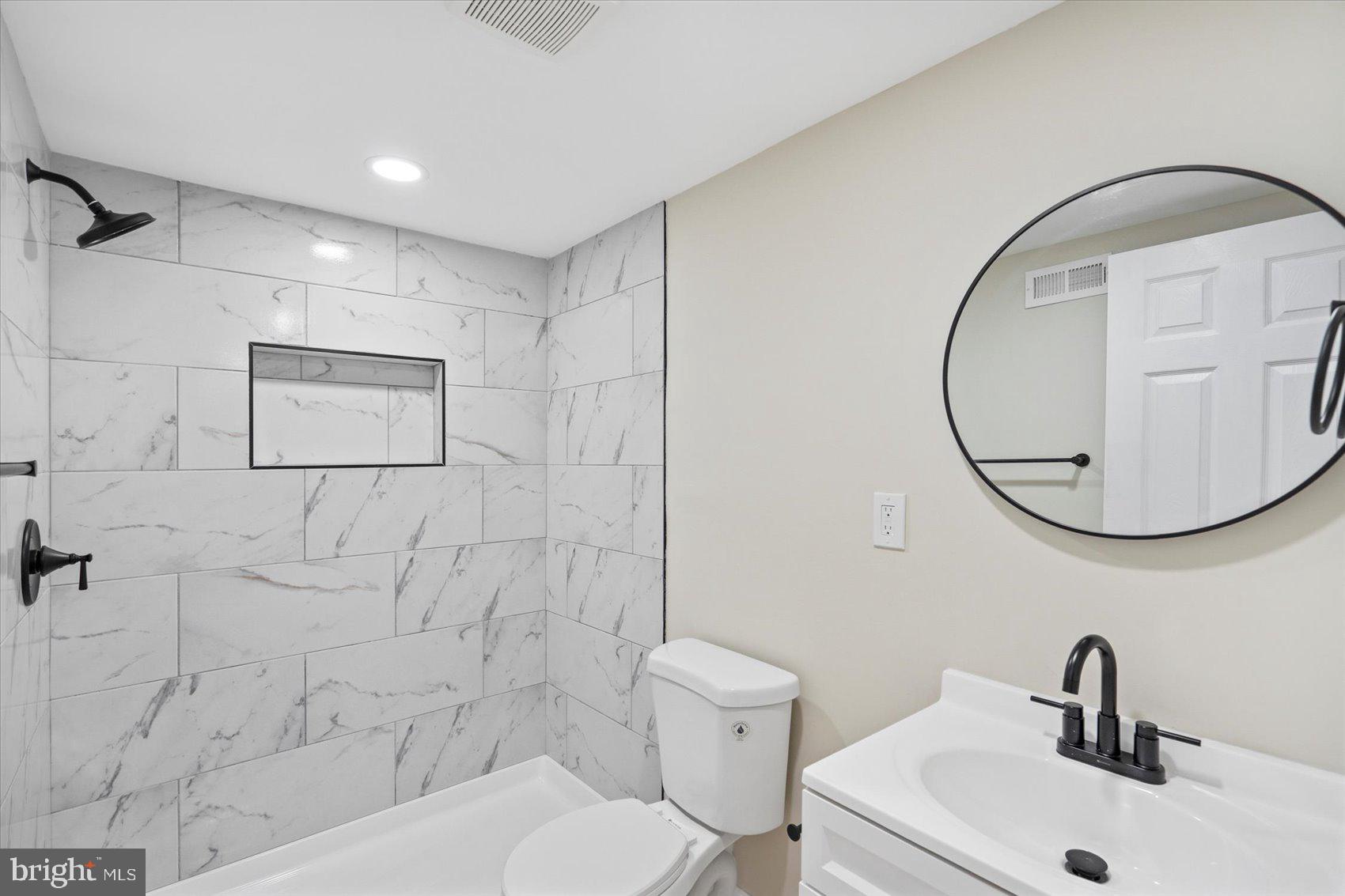 567 Shipley Road Linthicum Heights, MD 21090 - Photo 35 of 42 a bathroom with a toilet sink and mirror