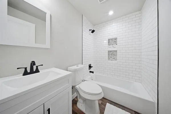 a bathroom with a sink a toilet and a bathtub