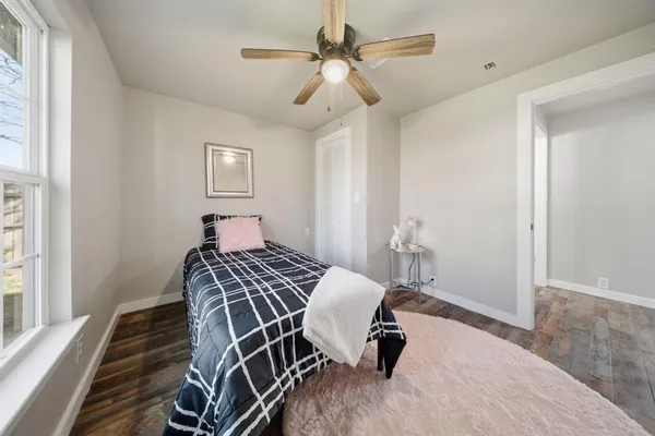 a bedroom with a bed and a chandelier