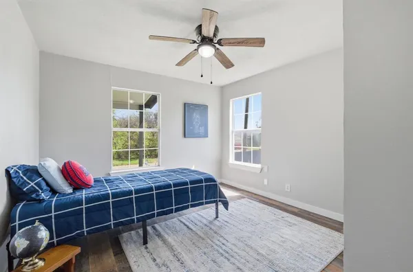 a bedroom with bed and windows