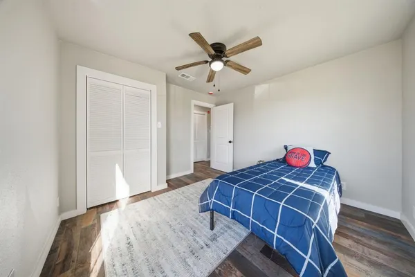 a bedroom with a bed and a chandelier