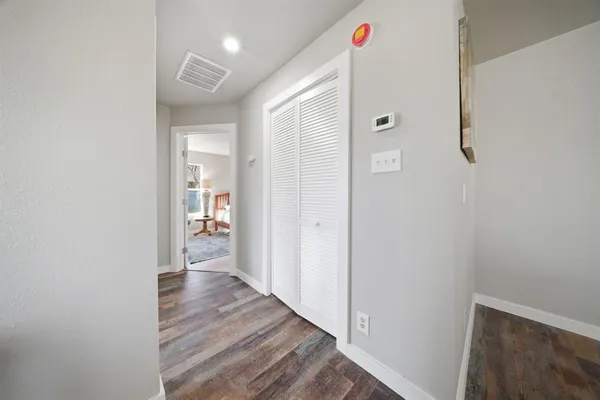 a view of a hallway with wooden floor