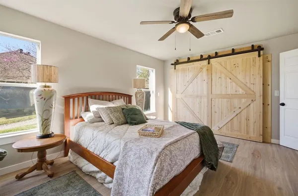 a bedroom with a bed a window and a chandelier