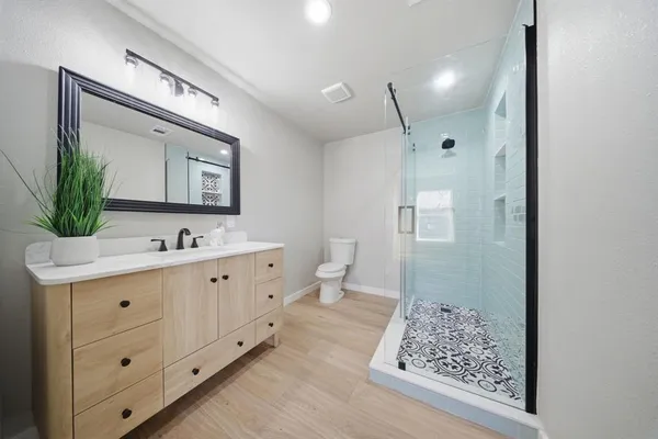 a spacious bathroom with a double vanity sink mirror and toilet