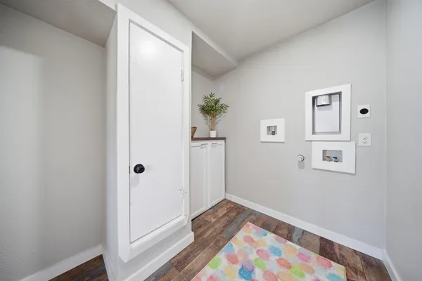 a view of hallway with wooden floor