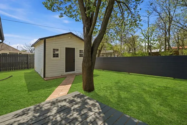 a view of a backyard with a large tree