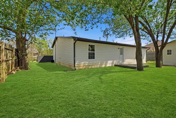 a backyard of a house with lots of green space