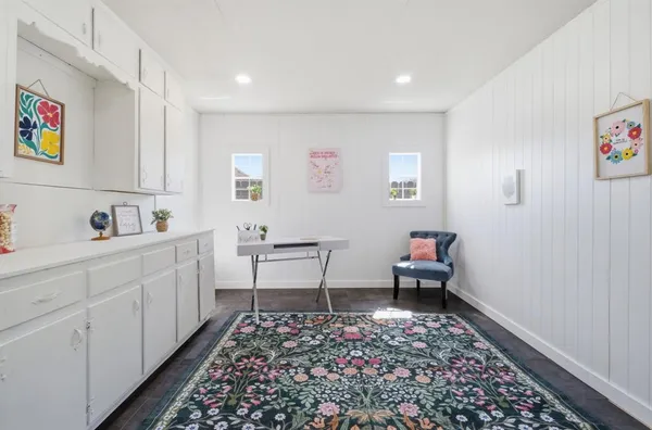 a living room with furniture and a rug