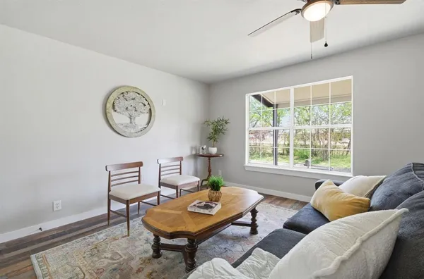 a living room with furniture a clock and a window