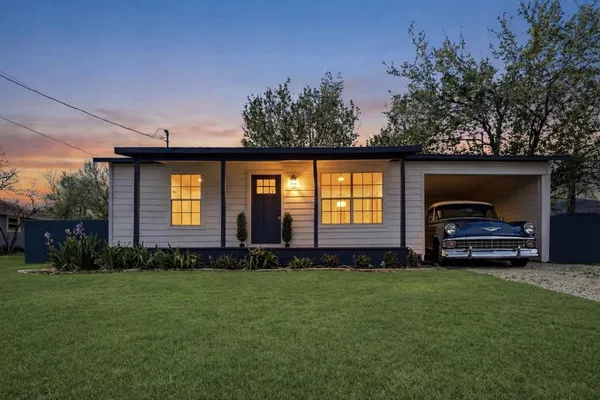 a front view of a house with a garden