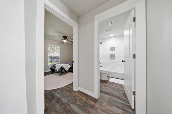 a view of a room with wooden floor bathroom and a bathroom