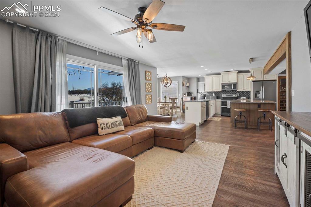 3815 Sierra Vista Road Monument, CO 80132 - Photo 14 of 44 a living room with furniture wooden floor and a large window