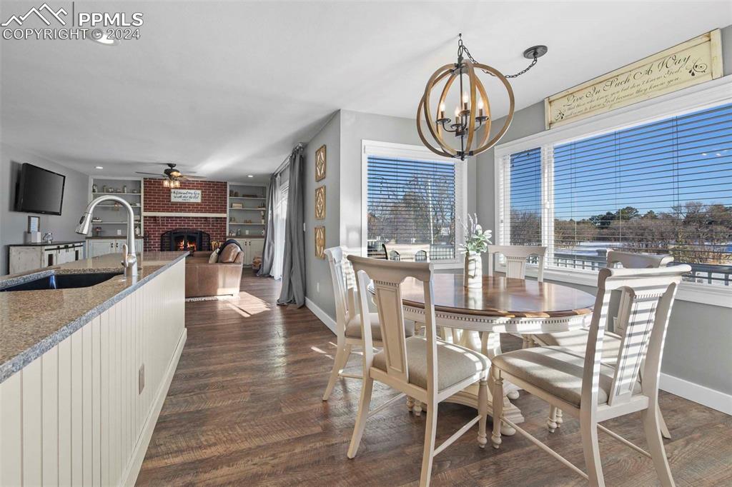 3815 Sierra Vista Road Monument, CO 80132 - Photo 15 of 44 a view of a dining room with furniture window and wooden floor