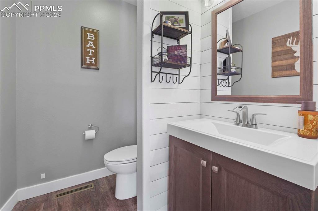 3815 Sierra Vista Road Monument, CO 80132 - Photo 16 of 44 a bathroom with a granite countertop sink mirror and a toilet