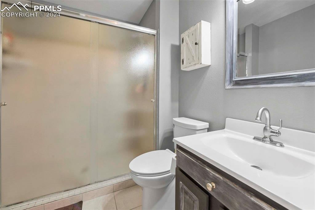 3815 Sierra Vista Road Monument, CO 80132 - Photo 21 of 44 a bathroom with a sink a toilet and shower