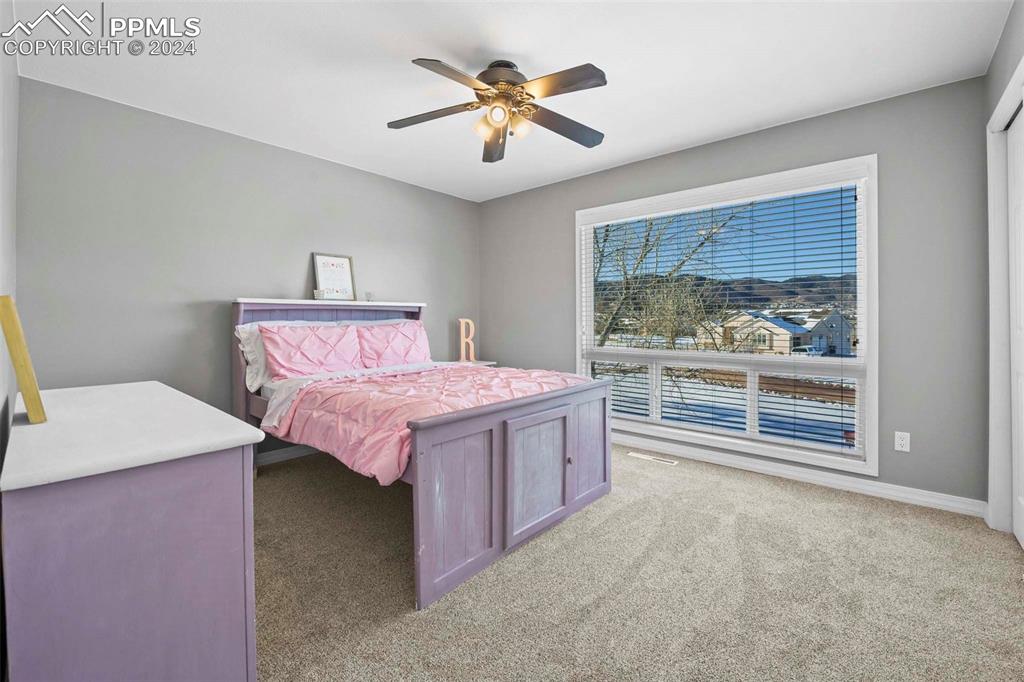 3815 Sierra Vista Road Monument, CO 80132 - Photo 22 of 44 a spacious bedroom with a bed and a table