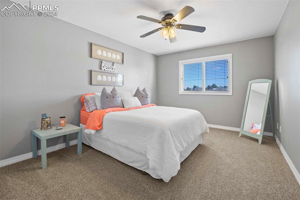 3815 Sierra Vista Road Monument, CO 80132 - Photo 25 of 44 a bedroom with a bed and a window