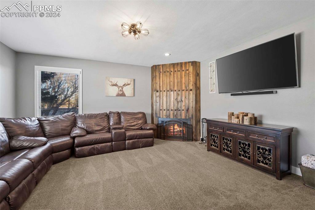 3815 Sierra Vista Road Monument, CO 80132 - Photo 5 of 44 a living room with furniture and a flat screen tv