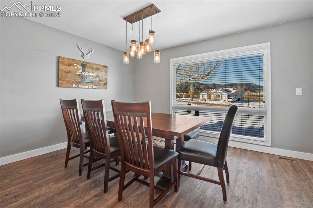 3815 Sierra Vista Road Monument, CO 80132 - Photo 7 of 44 a view of a dining room with furniture wooden floor and chandelier