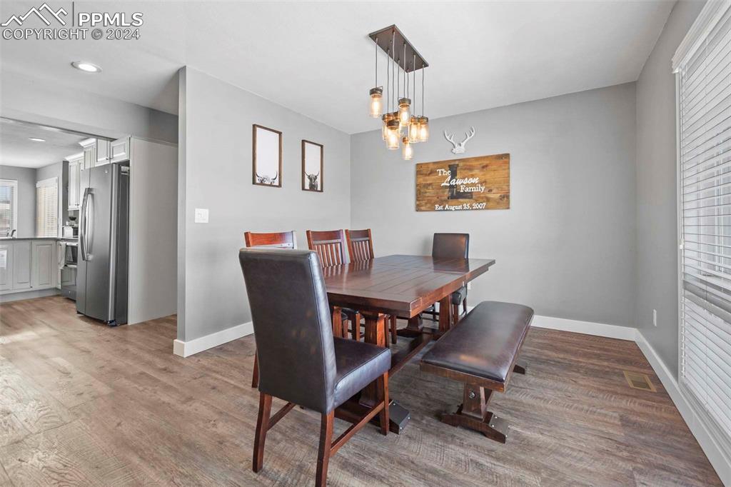 3815 Sierra Vista Road Monument, CO 80132 - Photo 8 of 44 a view of a dining room with furniture and wooden floor