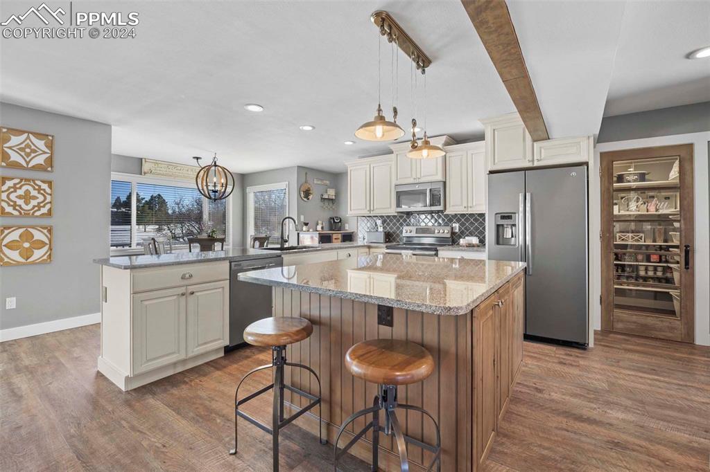 3815 Sierra Vista Road Monument, CO 80132 - Photo 9 of 44 a kitchen with stainless steel appliances a sink and a refrigerator