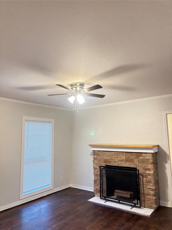 822 Oak Street Grand Prairie, TX 75050 - Photo 2 of 3 a view of an empty room with wooden floor fireplace and a window