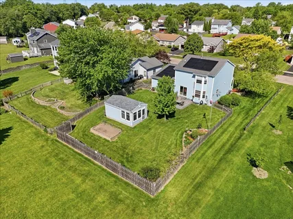 an aerial view of a residential houses with outdoor space