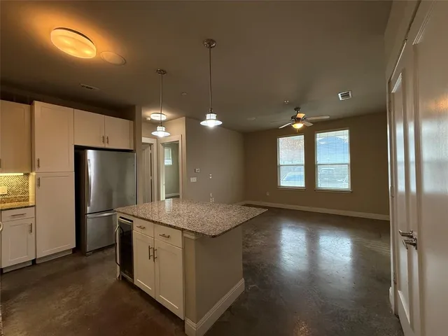 a kitchen with stainless steel appliances granite countertop cabinets and wooden floor